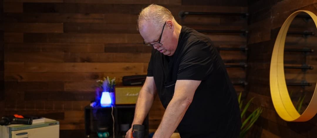 Jeff delivering targeted percussion therapy at the gym